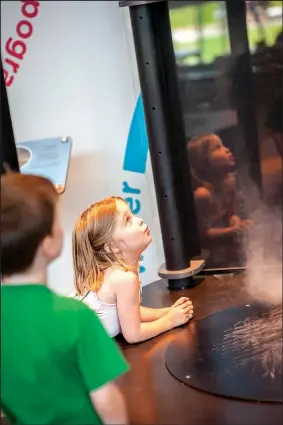  ?? NWA DEMOCRAT-GAZETTE/LARA JO HIGHTOWER ?? Emme loved watching the tornado form in the Energizer Weather and Nature exhibit.