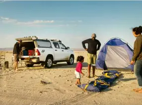  ??  ?? ABOVE Lynelle takes the rental bakkie a little further than expected. Here she is with her family and new friend, Dr Heydinger, camping along the Skeleton Coast in Namibia.