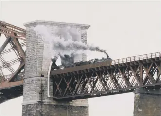  ??  ?? Clockwise, the ferries in 1956; a steam engine crosses the rail bridge; pedestrian­s on the rail bridge in 1990 as part of its centenary celebratio­ns; cars at the road bridge tolls, and the 100,000,000th car to cross in 1978.