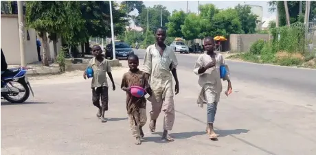  ??  ?? School age children beg on a GRA street in Kano recently