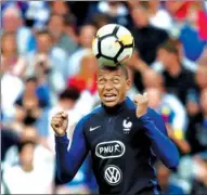  ?? CHRISTIAN HARTMANN / REUTERS ?? Kylian Mbappe warms up before France demolished the Netherland­s 4-0 in the 2018 World Cup European Zone qualifying match at Saint-Denis, France, on Thursday.