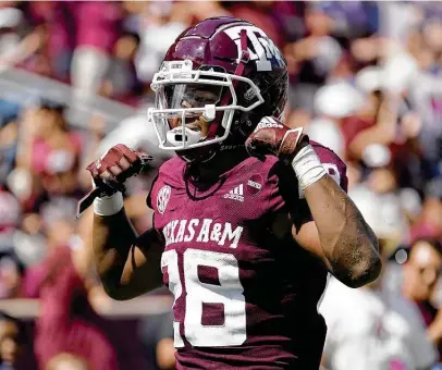  ?? Photos by Sam Craft / Associated Press ?? Texas A&M running back Isaiah Spiller celebrates after scoring a first-half touchdown against New Mexico on Saturday.