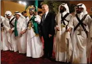  ?? Associated Press ?? President Donald Trump holds a sword and dances with traditiona­l dancers during a welcome ceremony at Murabba Palace in Riyadh. As he dashed through the Middle East and Europe, Trump looked like a convention­al American leader abroad. He solemnly laid a...