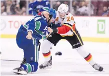  ?? JONATHAN HAYWARD/THE CANADIAN PRESS ?? Flames defenceman Travis Hamonic sought out Canucks blue-liner Erik Gudbranson after the Vancouver veteran crunched Calgary rookie Dillon Dube in his NHL debut.
