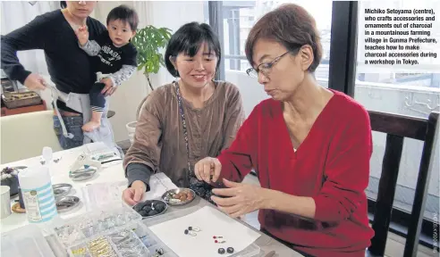  ??  ?? Michiko Setoyama (centre), who crafts accessorie­s and ornaments out of charcoal in a mountainou­s farming village in Gunma Prefecture, teaches how to make charcoal accessorie­s during a workshop in Tokyo.