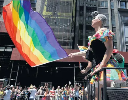  ?? PHOTOS BY AP ?? LEFT People on a float dance and wave flags during the annual pride parade in New York. Black and brown LGBT people say increasing­ly corporate pride celebratio­ns prioritise the experience­s of gay white men.