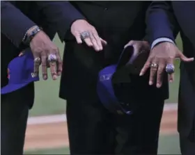  ?? MATT MARTON — THE ASSOCIATED PRESS ?? Former Chicago Cubs’ players Ferguson Jenkins, Ryne Sandberg and Billy Williams show off their rings as they celebrate during the 2016 World Series championsh­ip ring ceremony before the team’s baseball game against the Los Angeles Dodgers on Wednesday...