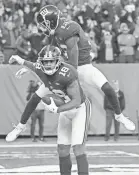  ??  ?? Giants receiver Roger Lewis (18) celebrates with Tavarres King after making a catch in overtime Sunday. ROBERT DEUTSCH/USA TODAY SPORTS