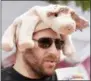  ?? FILE PHOTO ?? Adam Tapper of Albany wears a pig hat during the seventh anual Troy Pig Out.