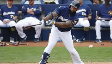  ?? PHOTO/MATT YORK ?? Milwaukee Brewers’ Eric Thames follows through on an RBI-base hit against the Colorado Rockies during the fourth inning of a spring training baseball game on Saturday, in Phoenix. AP