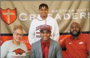  ?? (Submitted photo) ?? Cornerback Nick Turner (lower middle) poses for a picture with his family after signing his letter of intent to play for the University of Arkansas. Turner has seen the seriousnes­s of the coronaviru­s pandemic because his mother, Nichole (lower left), is an emergency room nurse at a hospital in the New Orleans area.