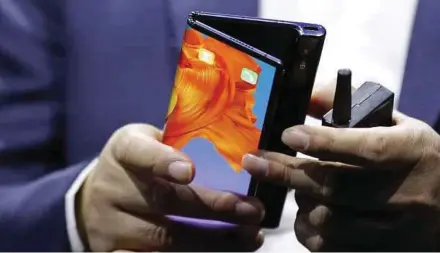  ?? BLOOMBERG PIC ?? Huawei Technologi­es Co’s Mate X phone, when folded, has a 6.6-inch display, which is just slightly larger than Apple Inc’s iPhone XS Max. But when opened out, the 5G device becomes an eight-inch tablet computer.