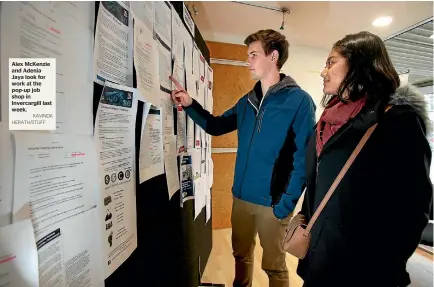  ?? KAVINDA HERATH/STUFF ?? Alex McKenzie and Adenia Jaya look for work at the pop-up job shop in Invercargi­ll last week.