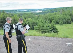  ?? SUBMITTED PHOTO ?? Cpl. Al Vincent, left, Prince District RCMP, and Const. Conor Hickey, Kings District RCMP, conduct a demonstrat­ion Wednesday at Strathgart­ney Provincial Park for the media on the new drones the police force has purchased. Officers from across P.E.I....