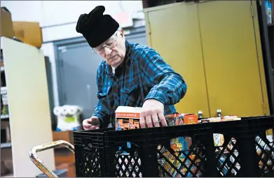  ?? GARY MIDDENDORF/DAILY SOUTHTOWN PHOTOS ?? Operation Blessing volunteer Al Anderson works Thursday on stocking shelves. Many food pantries like Operation Blessing in Alsip are expecting a rise in need if the federal government shutdown resumes.