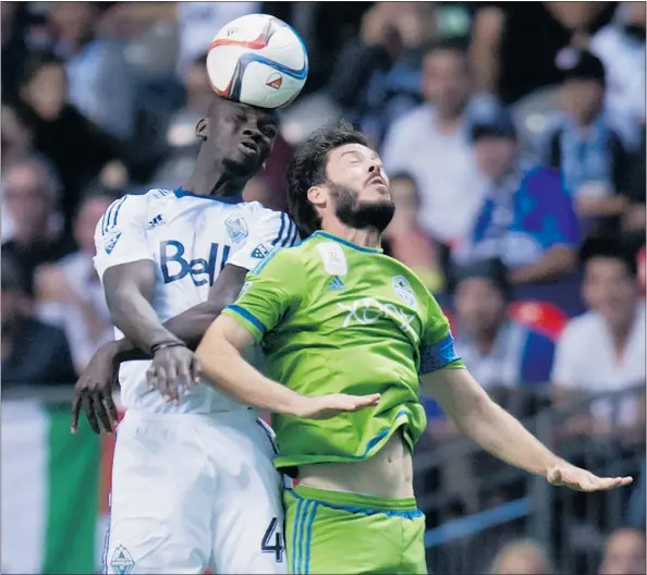  ?? — THE CANADIAN PRESS FILES ?? Vancouver Whitecaps veteran Pa-Modou Kah, left, will almost certainly get the start this weekend with the Houston Dynamo coming to town and regular centre-backs Kendall Waston and Tim Parker out after being called up to internatio­nal teams.