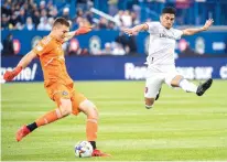  ?? GRAHAM HUGHES/THE CANADIAN PRESS VIA AP ?? CF Montreal’s goalkeeper Sebastian Breza clears the ball as Real Salt Lake’s Pablo Ruiz moves in during the second half of Sunday’s game in Montreal. Salt Lake rallied for a 2-1 win.