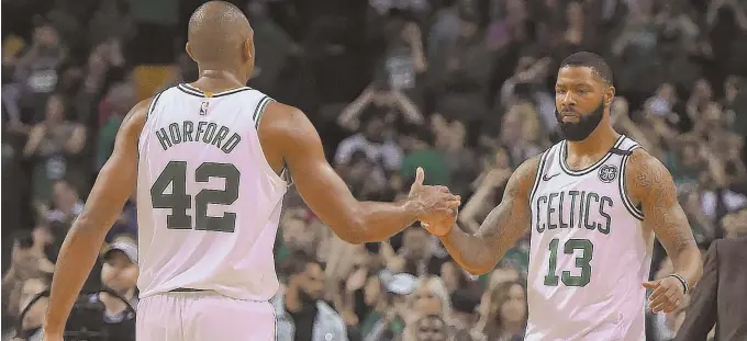  ?? STAFF PHOTO BY CHRISTOPHE­R EVANS ?? JOB WELL DONE: Al Horford (left) and Marcus Morris celebrate during the fourth quarter of the Celtics’ Game 5 victory against the Bucks last night at the Garden.