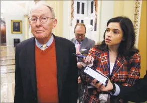  ?? Steve Helber / Associated Press ?? Sen. Lamar Alexander, R-Tenn., talks to reporters as he walks past the Senate chamber prior to the start of the impeachmen­t trial of President Donald Trump at the U.S. Capitol on Friday.