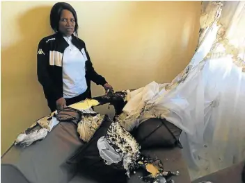  ?? Picture: SUPPLIED ?? NIGHTMARE ORDEAL: Ward 30 BCM ANC councillor Nomonde Moyikwa surveys her house after it was petrol-bombed.