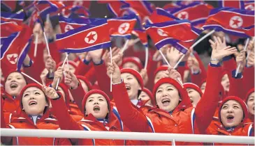  ?? AFP ?? North Korean cheerleade­rs attend a figure skating event at the Winter Olympics on Wednesday.