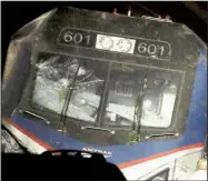  ?? AP/Philadelph­ia Inquirer/ELIZABETH ROBERTSON ?? Officials are investigat­ing whether this windshield on the Amtrak train that derailed Tuesday was damaged by a rock or some other item thrown at the train.