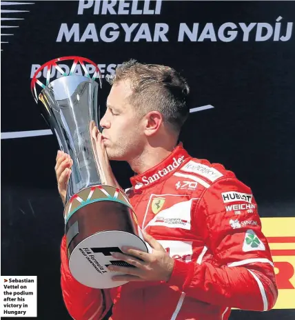  ??  ?? > Sebastian Vettel on the podium after his victory in Hungary