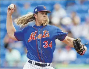  ?? JOHN BAZEMORE/THE ASSOCIATED PRESS ?? Expect the Mets’ Noah Syndergaar­d to ride his blazing fastball to Cy Young contention in the National League this season after striking out batters at a prodigious rate in 2016.