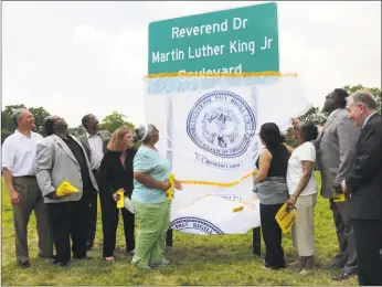  ?? Hearst Connecticu­t Media file photo ?? New Haven politician­s unveil a new sign designatin­g North Frontage Road as the Rev. Dr. Martin Luther King Jr. Boulevard in 2011.