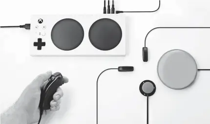  ?? MICROSOFT ?? The Xbox Adaptive Controller, $99.99 when released later this year, with various accessorie­s plugged in.