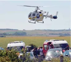  ?? — AFP ?? An helicopter of the emergency medical assistance SAMU arrives on the site after the police arrested a suspect on the A16 motorway, near Marquise, northern France, on Wednesday.