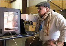  ?? NWA Democrat-Gazette/CHARLIE KAIJO ?? Trent Bower, production manager of the Arkansas Regional Innovation Hub of Little Rock, makes an adjustment on a 3-D printer during the event. Several 3-D printers were provided to help creators with their ideas.