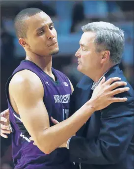  ??  ?? Bill Carmody, shown with Reggie Hearn, coached his last game with the Wildcats on Thursday, a 73-59 loss to Iowa. | CHARLES REX ARBOGAST~AP