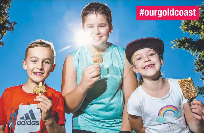  ?? Picture: JERAD WILLIAMS ?? Jack Wilkes, 8, Mitchell Hosking, 11, and Samantha Wilkes, 7, enjoying their ice creams at the Broadwater Parklands, Southport yesterday.