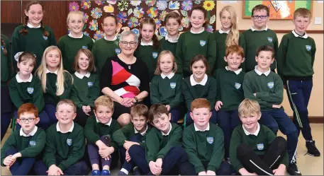  ??  ?? Bernie Costello (seated centre) at her retirement party with her third and fourth class pupils at Kilgobnet National School on Thursday. Photo by Michelle Cooper Galvin