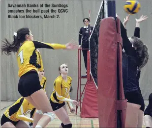  ??  ?? Savannah Banks of the SunDogs smashes the ball past the QCVC Black Ice blockers, March 2.