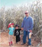  ?? COURTESY OF JACOB GRANT ?? Albuquerqu­e police detective Jacob Grant and his two children take a stroll through a field in this older family photo. Grant credits the image of his children for inspiring him to fight to live after he was shot in an undercover drug buy gone horribly...