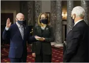  ?? NICHOLAS KAMM — POOL VIA AP ?? Sen. Mark Kelly, D-Ariz., with his wife former Rep. Gabby Giffords, D-Ariz., participat­es in a re-enactment of his swearing-in Wednesday by Vice President Mike Pence in the Old Senate Chamber on Capitol Hill in Washington.