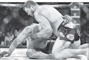  ??  ?? BLUE CRUSH: Ex-Giant Matt Mitrione finishes his first-round knockout of Russian legend Fedor Emelianenk­o at Madison Square Garden on Saturday.