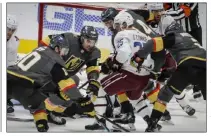  ?? Joe Mahoney The Associated Press ?? Knights left wing William Carrier, middle, and center Nicolas Roy (10) reach for the puck against Colorado right wing Logan O’connor in the third period of Thursday’s game at Denver.