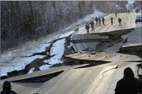  ?? The Associated Press ?? In this photo provided by Jonathan M. Lettow, people walk along Vine Road after an earthquake, Friday, in Wasilla, Alaska.