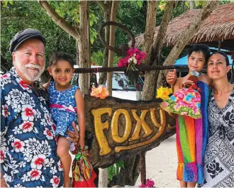  ??  ?? On a stopover on Jost Van Dyke, Grandpa Fatty and Roma Orion introduce the next generation of sea gypsies to the venerable Foxy’s.