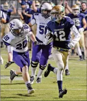  ?? PHOTO BY RANDY HOEFT/YUMA SUN ?? YUMA CATHOLIC’S J.R. HENDERSON (12) leaves Northwest Christian defenders Josh Heidel (20) and Aaron Gerle behind while returning a punt for a touchdown during the second quarter of a Sept. 22 game at Ricky Gwynn Stadium.