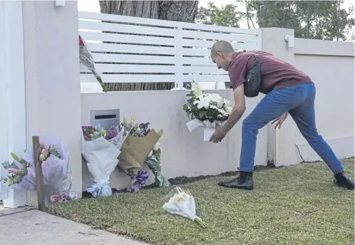  ?? ?? A man places flowers outside the Christ the Good Shepherd church in Sydney after a knife attack that wounded a bishop and a priest