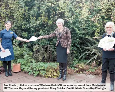  ??  ?? Ana Coelho, clinical matron of Wexham Park ICU, receives an award from Maidenhead MP Theresa May and Rotary president Mary Spinks. Credit: Maria Scavetta/Photogia