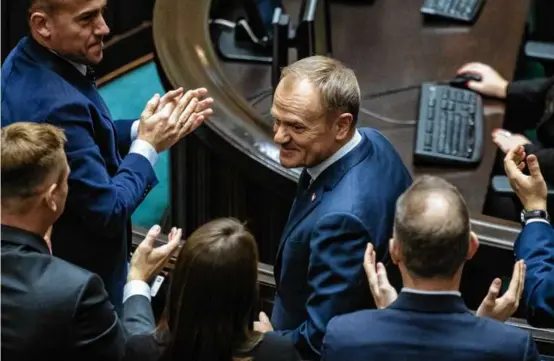  ?? WOJTEK RADWANSKI/AFP VIA GETTY IMAGES ?? Designated Polish Prime Minister Donald Tusk was applauded after giving a speech to present his program to lawmakers at the Polish Parliament in Warsaw on Tuesday.
