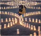  ?? GETTY IMAGES PHILIP FONG/AFP VIA ?? A visitor is surrounded by paper lanterns at a disaster memorial in Tokyo on Thursday.