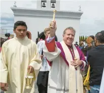  ?? ?? The Rev. Robert McClory, of the Gary Diocese, blesses the grounds.