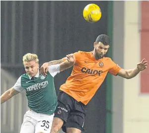  ?? Pictures: SNS Group. ?? United’s Mark Durnan in an aerial bout with Jason Cummings, and, below: John Souttar slides in to challenge John McGinn.