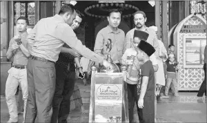  ??  ?? Members of the public giving donations during a special fundraiser for Rohingya community at Masjid Putra. — Bernama photo